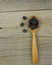 Blackberries with spoon on wooden background closeup shot