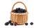 Blackberries in wicker basket isolated on white