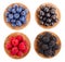 Blackberry blueberry raspberry black currant in wooden bowl isolated on white background. Top view. Set or collection