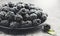 Blackberry close up. Fresh ripe organic blackberries in a bowl closeup on grey