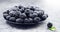 Blackberry close up. Fresh ripe organic blackberries in a bowl closeup on grey