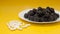 Blackberry on yellow table in white plate, Real Vitamins or handful of Pills Concept