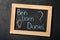 Blackboard with baby names on black stone table, top view