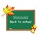 Blackboard decorated with autumn maple leaves