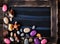 Blackboard decorated with sea objects shaped candies and pebbles