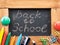 Blackboard inscribed in chalk `Back to school`.