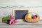 Blackboard with pink tulips and basket with eggs