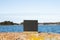 Blackboard standing on a rock. Blue sky with clouds and blue sea on background.