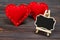 Blackboard on wooden background with red heart. Copy space