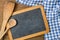 Blackboard with wooden spoons on a blue checkered tablecloth