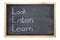 Blackboard with words Look Listen Learn