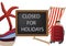 Blackboard with written closed for holidays-