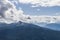 Blackcomb mountain peak panorama view cloudy sky summer time.