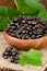 Blackcurrant Berries in Wooden Bowl