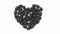 A blackened heart sculpted out of blackberries