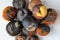 Blackened, moldy, rotten apples on a white table. Top view. Close-up