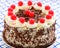 Blackforest gateau decorated with the traditional cream, chocolate flakes and cherries