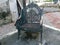 blackish gray iron garden chair on the roadside sidewalk