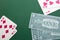Blackjack combinations of playing cards on green felt and money