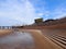 Blackpool in summer from the beach and seafront with promenade and pier with modern modern wedding chapel building and tourists wa