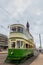 BLACKPOOL, UK, JUNE 30 2019: A Heritage Tram travels along the tramway with Blackpool Tower in the background
