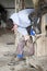 Blacksmith Cleaning a Horses Hoof