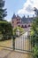 Blacksmith gate, wooden bridge to Het Oude Loo castle surrounded by green vegetation