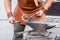 Blacksmith handles the horseshoe on the anvil