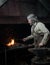 Blacksmith heats item before forging