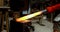 Blacksmith shaping hot metal rod in machine 4k