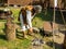 A blacksmith in a street forge shows the process of forging metal