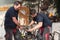 Blacksmith team working on the anvil, making a horseshoe.