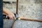 A blacksmith is using a sharpener, sparks come out while cutting