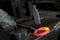 A blacksmith at work with glowing irons. Hot iron forge, a black