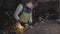 Blacksmith working in a workshop with metal via angle grinder, slow motion.