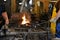 Blacksmiths in a forge shaping metal