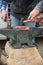 Blacksmiths forging an incandescent horseshoe