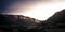 The blades of some windmills emerge from the peaks of the Badaia Mountains