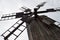 Blades of wooden windmill against the sky