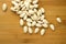 Blanched almonds scattered on a wooden board