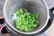 Blanched celery in a colander in ice water