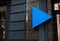 Blank advertisements blue triangle on stone building wall