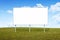A blank advertising billboard immersed in a grass field