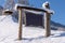 Blank advertising billboard with wood frame  in the snowy  mountains . Empty copy space