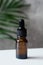 Blank amber glass essential oil bottle with dropper. Natural organic cosmetics package mockup. Alternative medicine, herbal