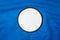 Blank arm patch on blue sport shirt. White team logo and emblem for your montage or edit