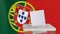 Blank ballot with space for text or logo is dropped into the ballot box against the backdrop of the flag of Portugal. E