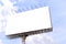 Blank billboard with rusted structure against blue sky for advertisement