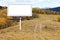 Blank Billboard Sign Along Dirt Trail in Mountains