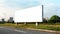 Blank billboard stands at roadside